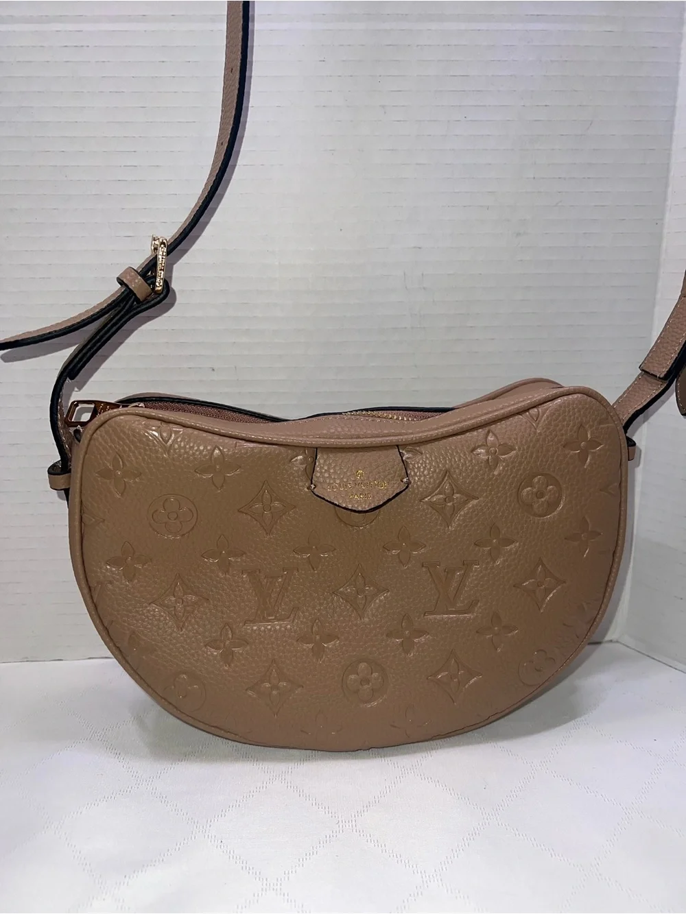 Designer inspired half-moon shoulder bag in a neutral taupe leather w/monogram